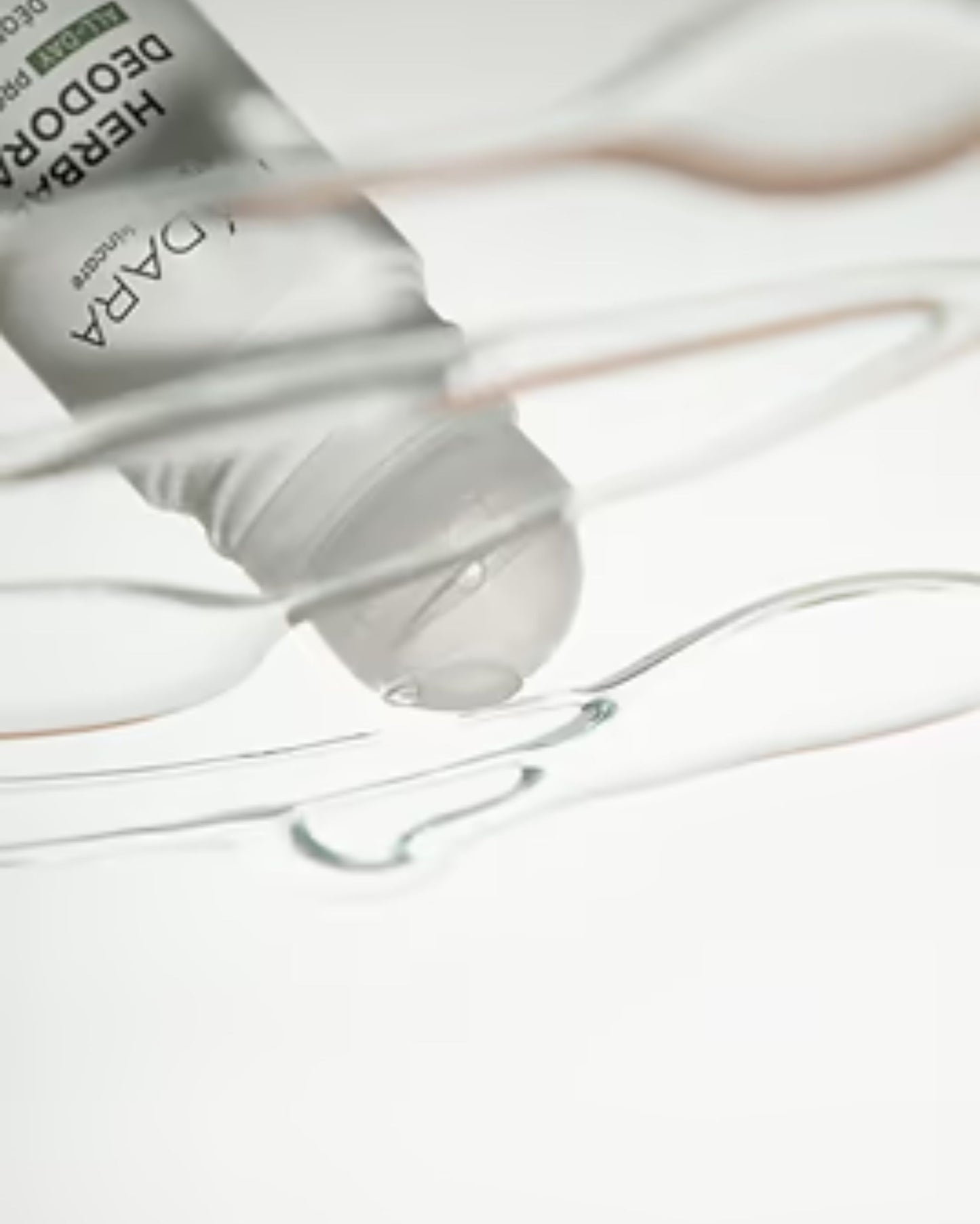 Close-up of a dropper bottle with a clear liquid on a light background