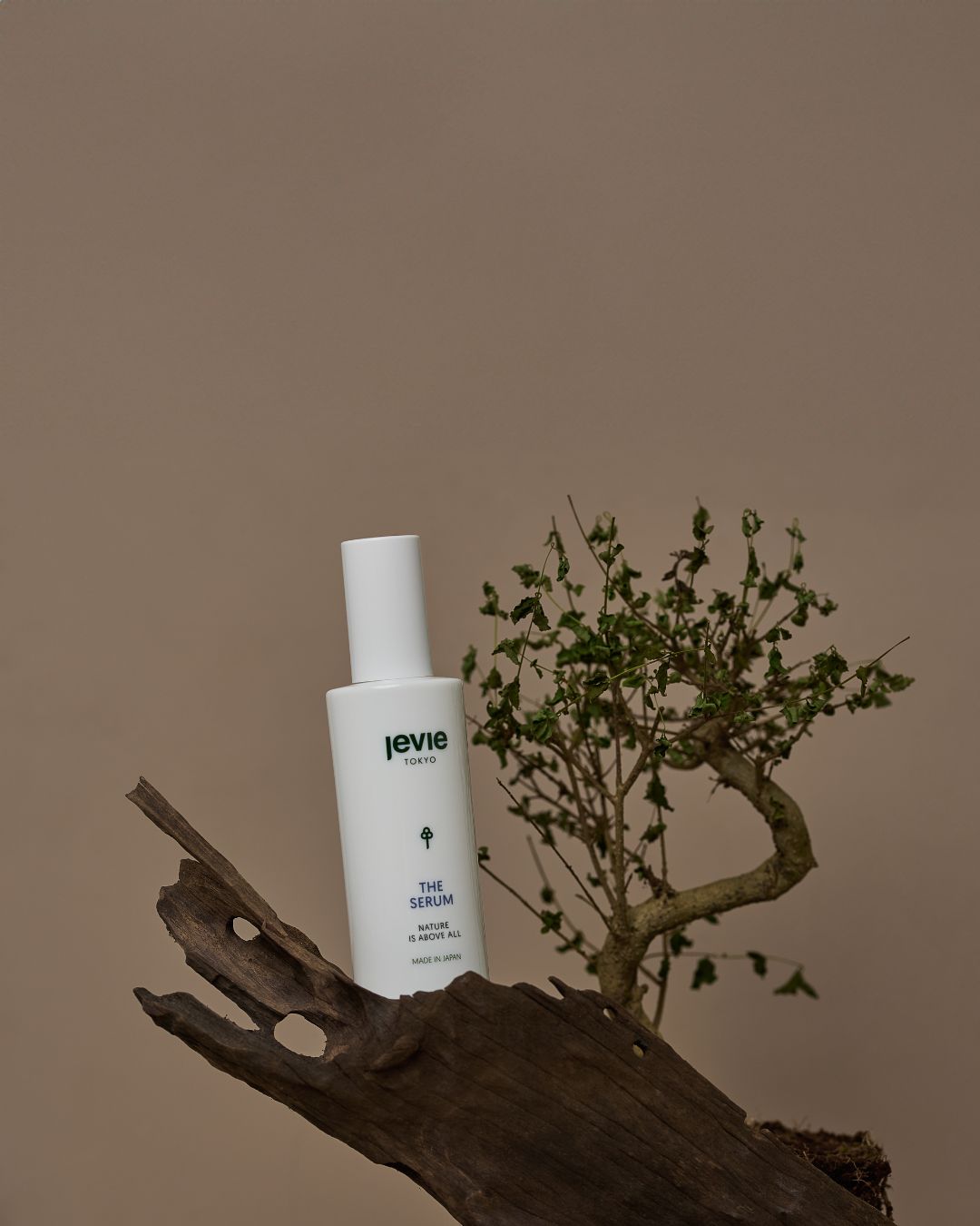 White bottle labeled 'levie' on a wooden surface with a minimal background