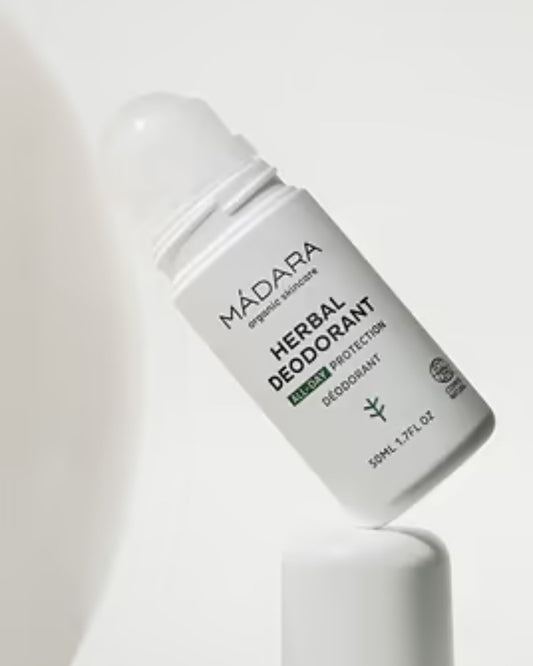 Mádara Herbal Deodorant bottle on a light gray background