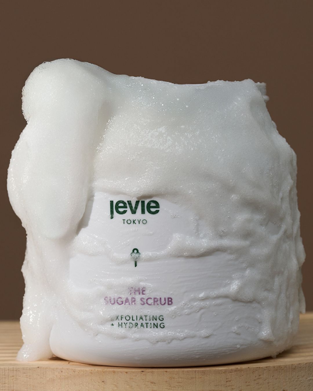 Levie Tokyo sugar scrub on a wooden surface with a brown background