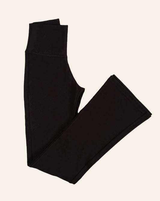 Folded black leggings on a white background