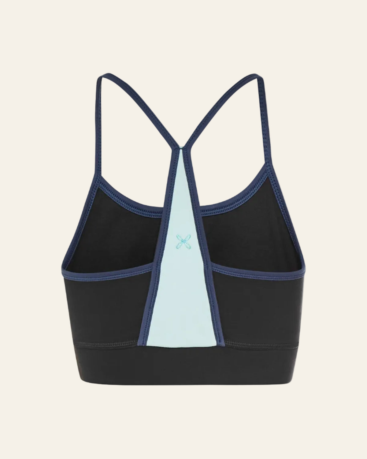 Black sports bra with blue accents on a beige background 