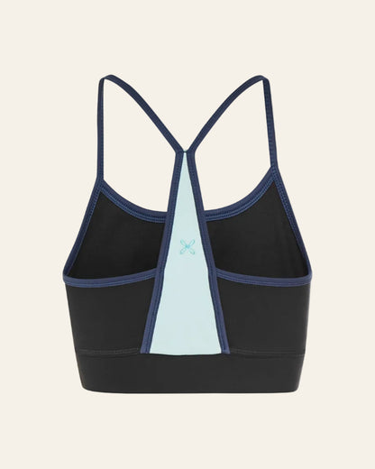 Black sports bra with blue accents on a beige background 