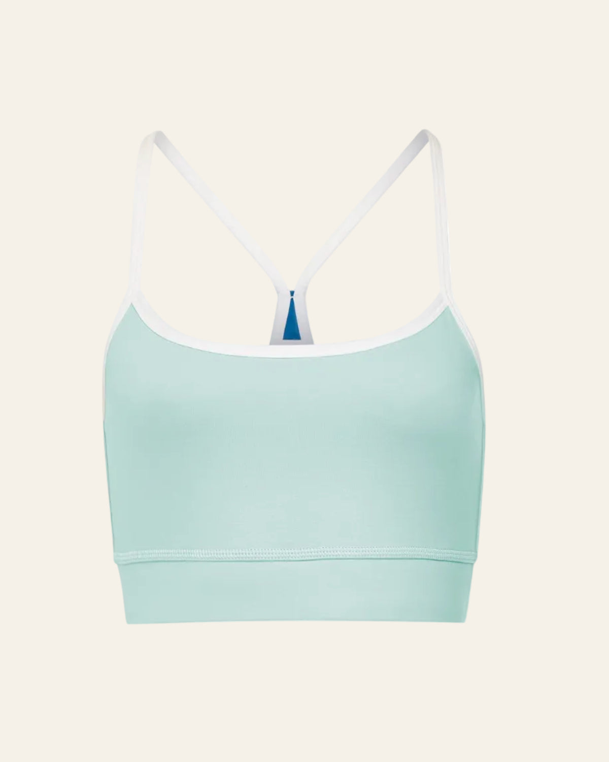 Light blue sports bra with white straps on a beige background