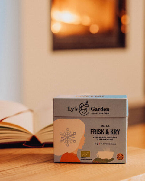 Box of Ly's Garden tea on a wooden surface with a blurred background