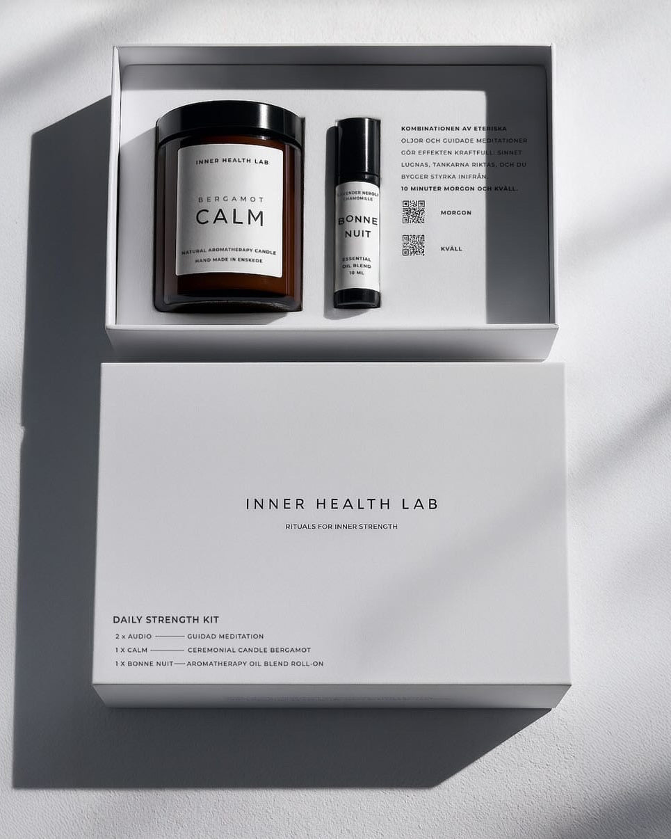 Inner Health Lab daily strength kit with a candle and rollerball on a light gray background