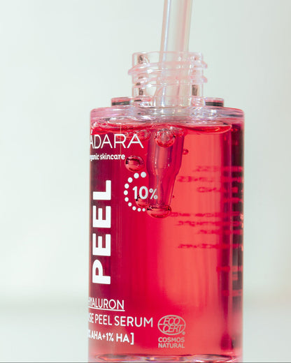 Red serum bottle with dropper labeled 'MADARA' on a light background