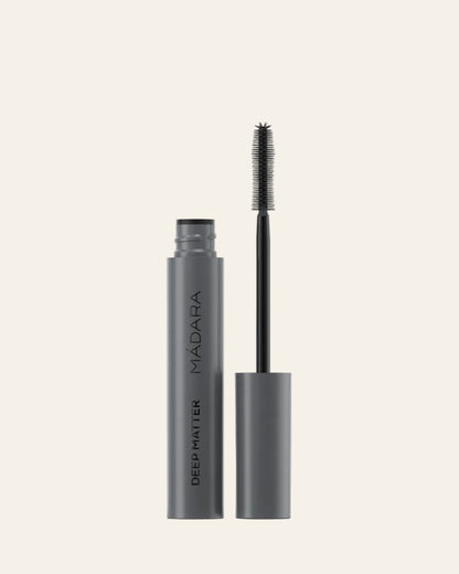 Mascara with black wand and gray casing on a white background